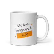 White mug with the phrase “My love language is kafe” in a modern design with orange accents.