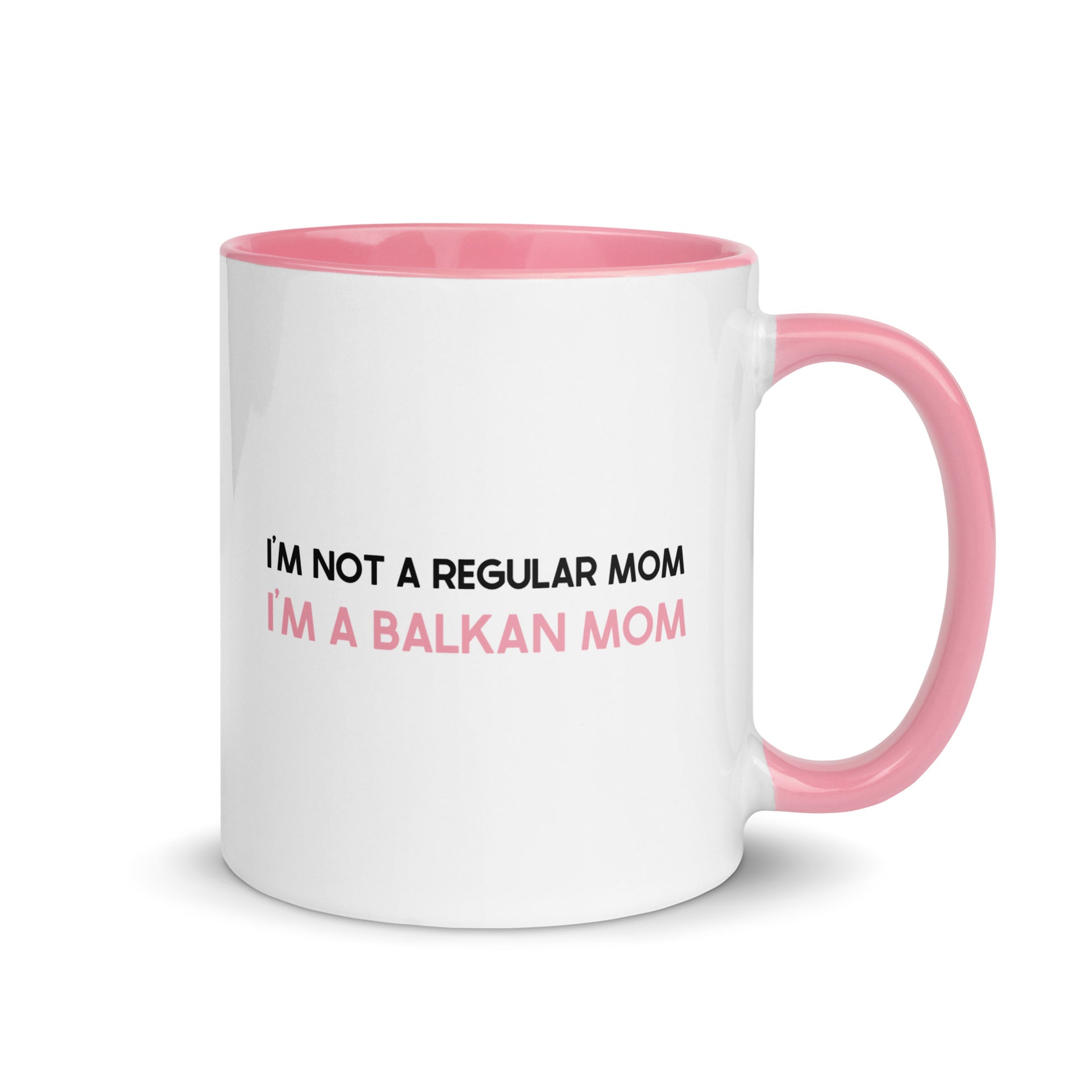 White mug with pink handle reading “I’m not a regular mom, I’m a Balkan mom.”
