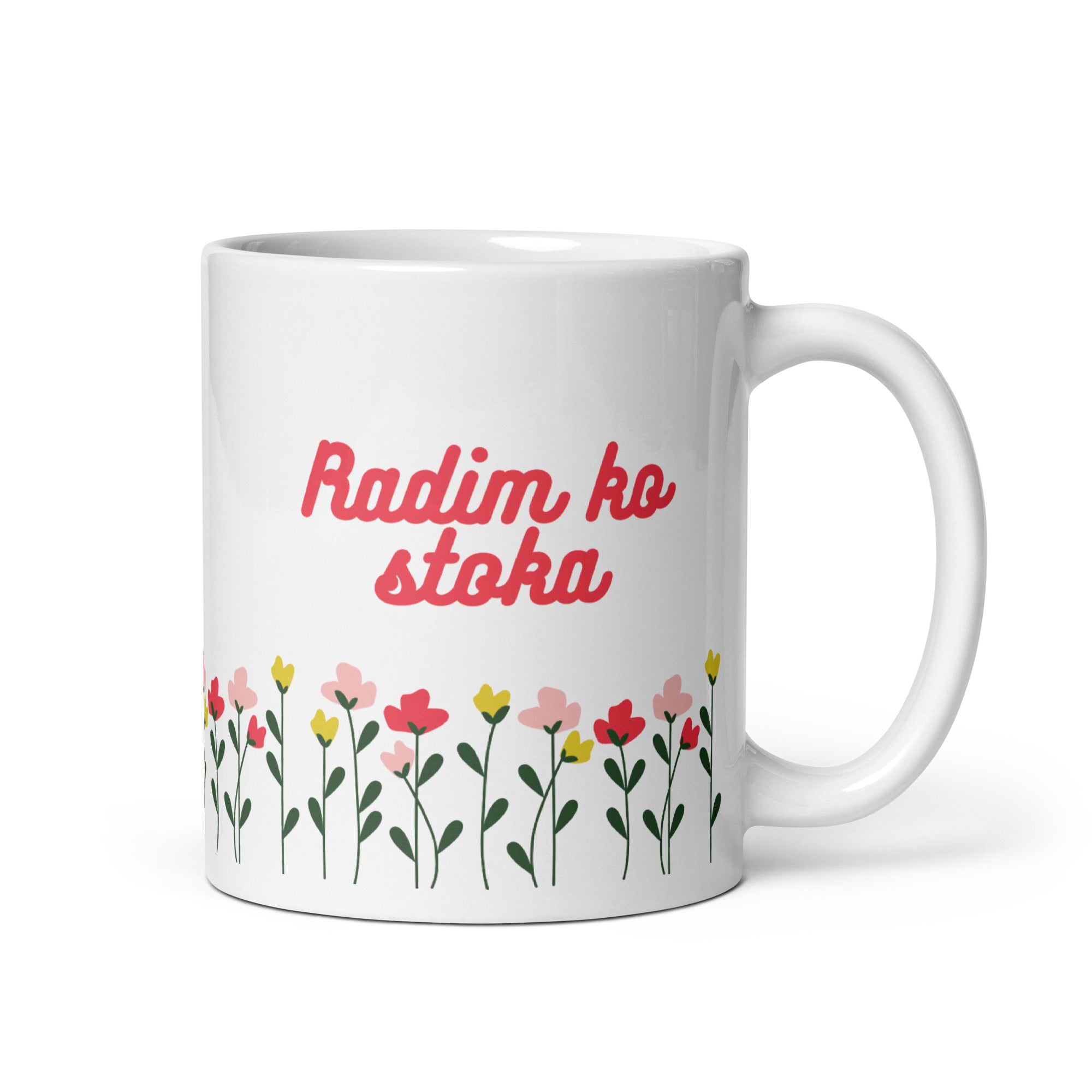 White mug with red text reading “Radim ko stoka” above colorful flowers.