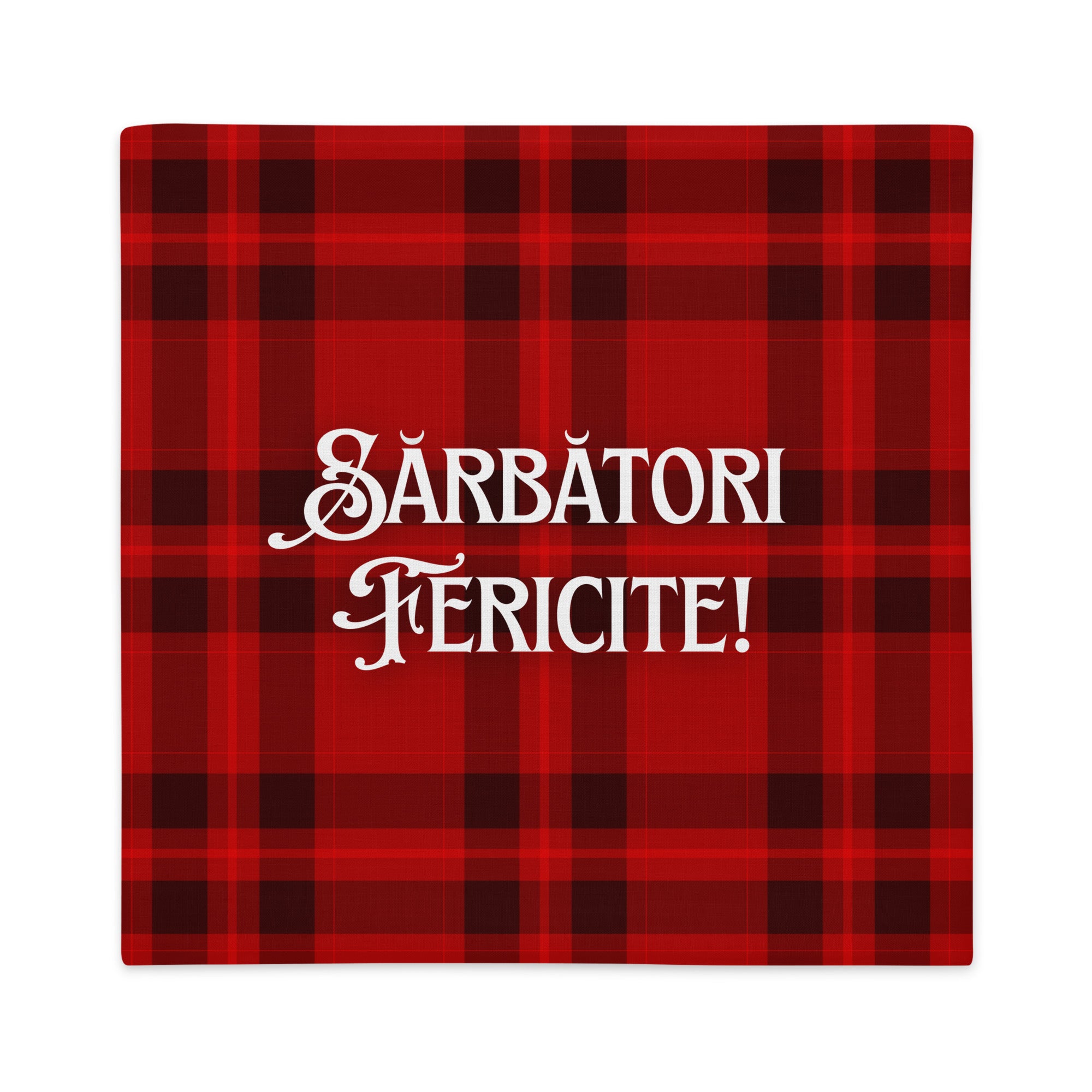 Romanian “Sărbători Fericite” pillowcase on red plaid background, festive holiday design.