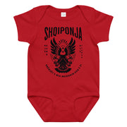 Red and black Albanian eagle baby onesie featuring “Rrënjët e mia rrjedhin kuq e zi.”