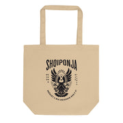 Neutral tote bag with red Albanian double-headed eagle and “Rrënjët e mia rrjedhin kuq e zi” design.