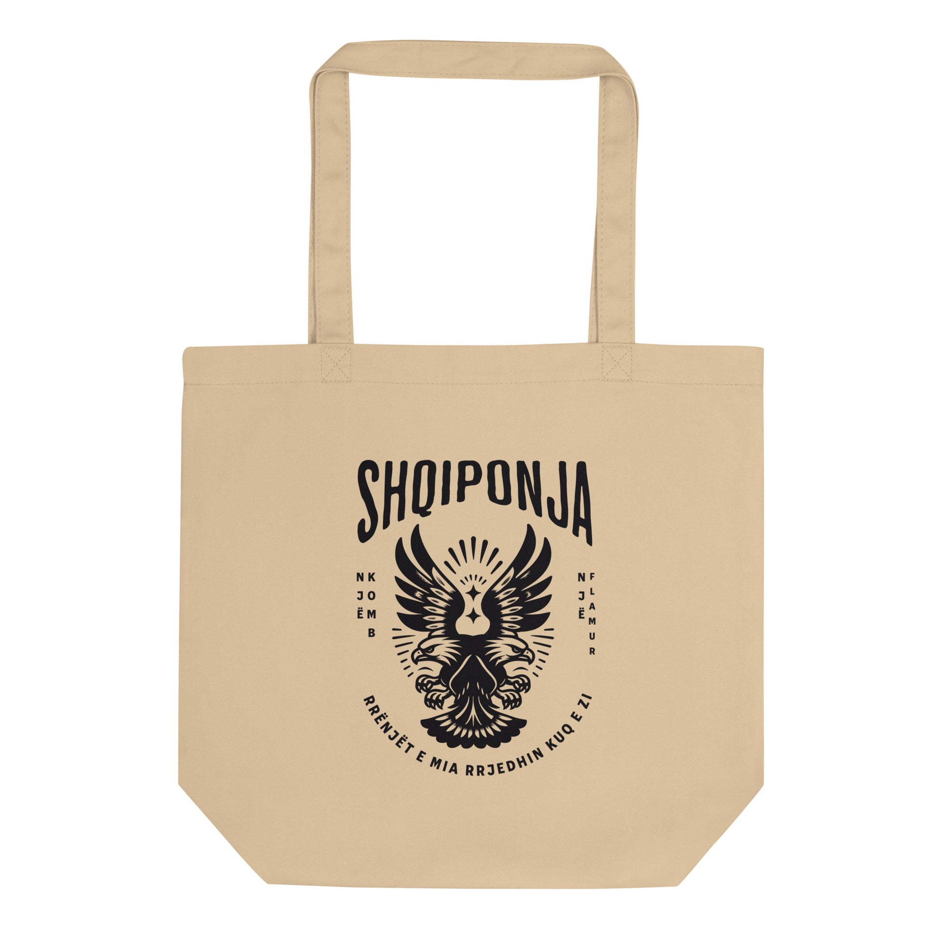 Neutral tote bag with red Albanian double-headed eagle and “Rrënjët e mia rrjedhin kuq e zi” design.