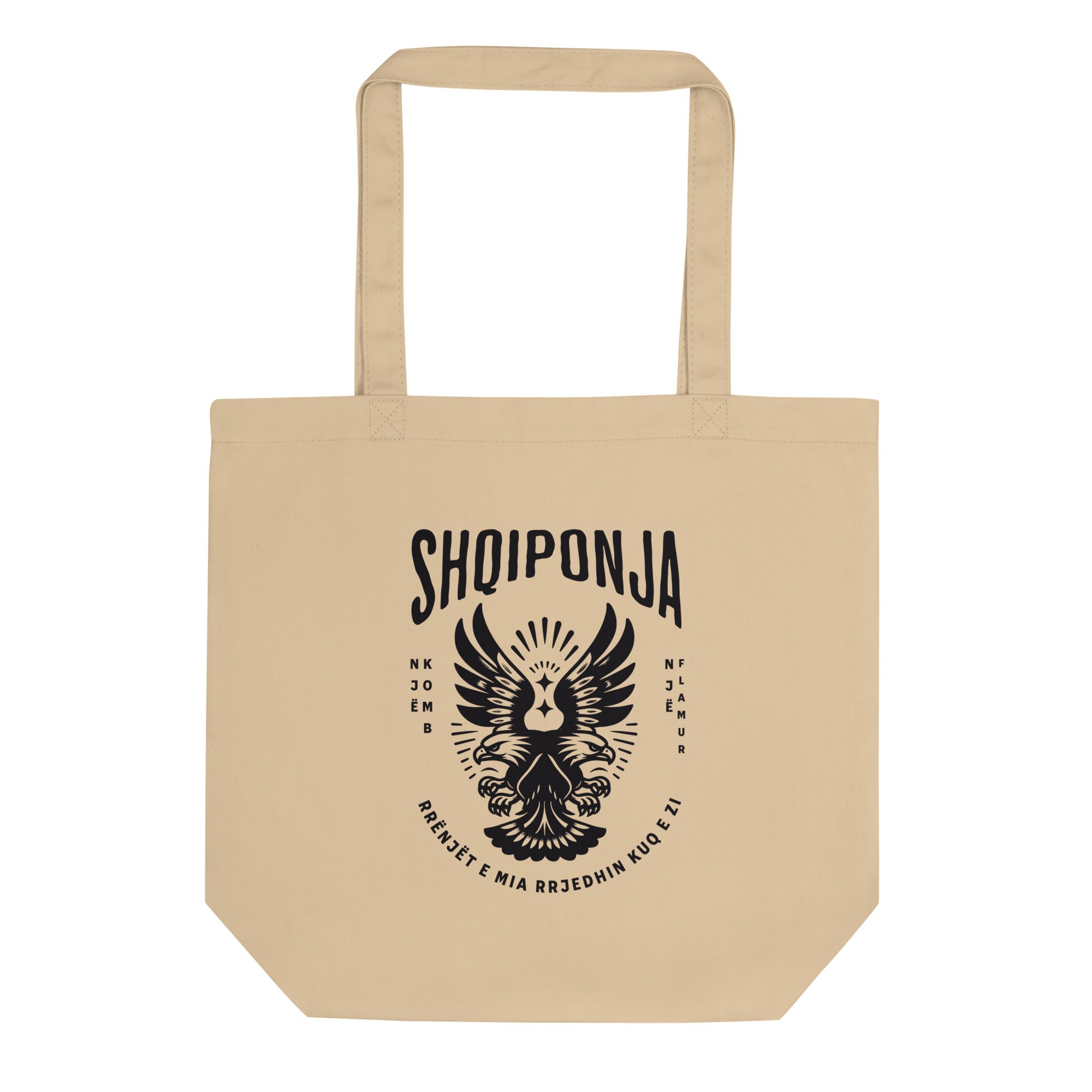 Neutral tote bag with red Albanian double-headed eagle and “Rrënjët e mia rrjedhin kuq e zi” design.