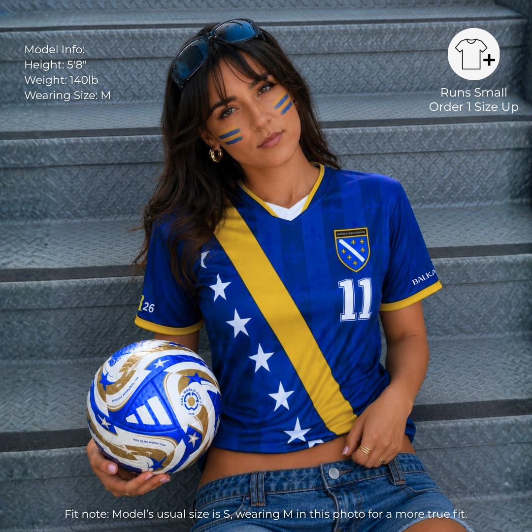 Woman wearing Bosnia-inspired Bosna Je Stigla football jersey with blue and gold diagonal stripe design