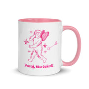 White mug with pink handle and interior featuring a cupid illustration and the Bosnian phrase “Pucaj, šta čekaš!”