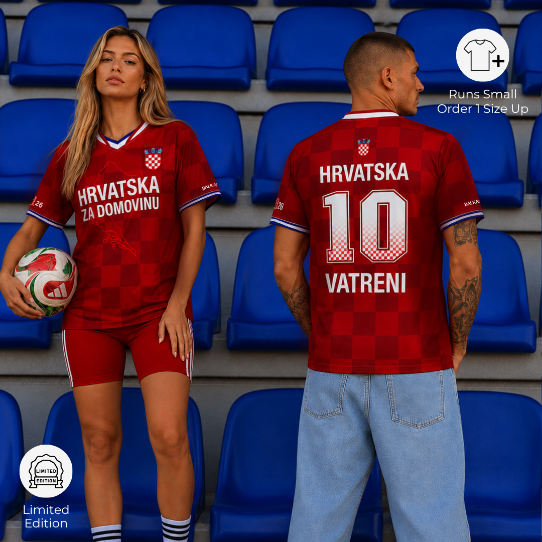 Man and woman wearing matching Croatia-inspired football jerseys styled as modern Balkan streetwear in stadium seats