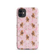 Pink phone case covered in gingerbread men playing the accordion with holiday candy canes and snowflakes.
