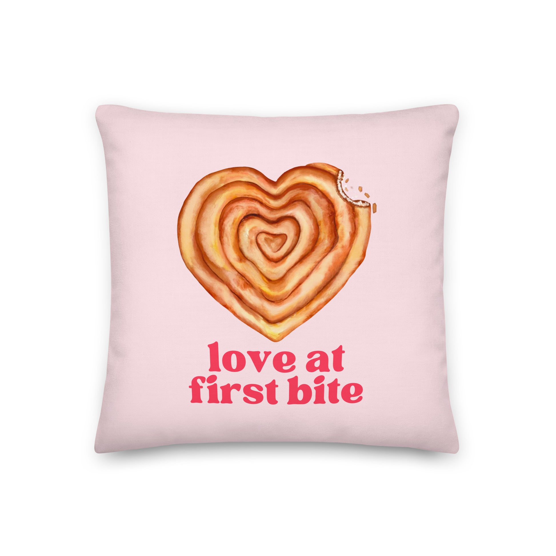 Pillow with text “Love at First Bite” and a heart-shaped burek with a bite taken out