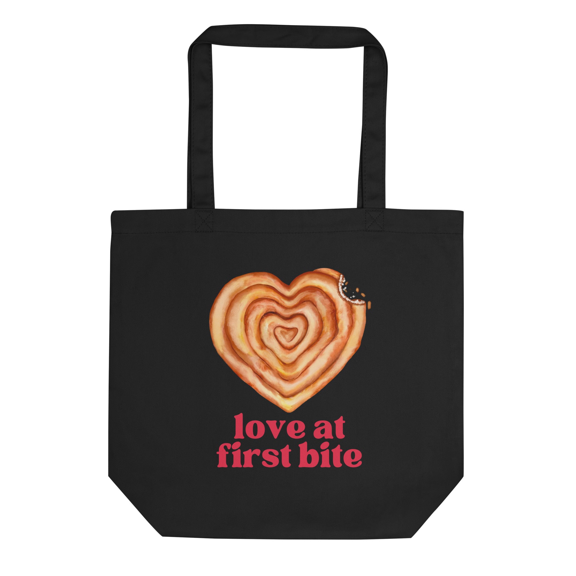 Black tote bag with heart shaped burek illustration and text “Love at First Bite”