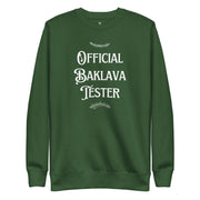 Green Christmas crewneck with “Official Baklava Tester” text
