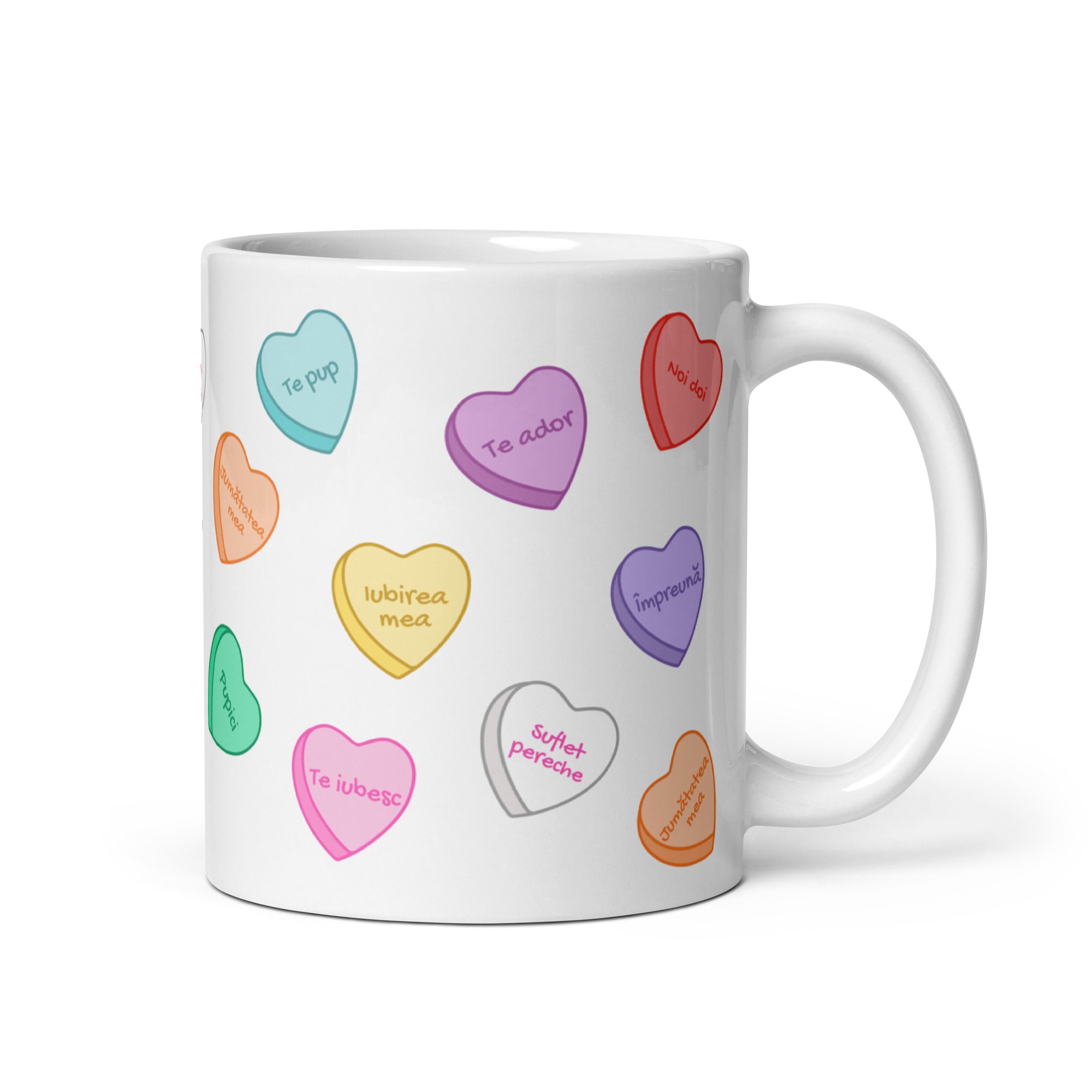 White mug with colorful Sweethearts candy heart pattern and love phrases.