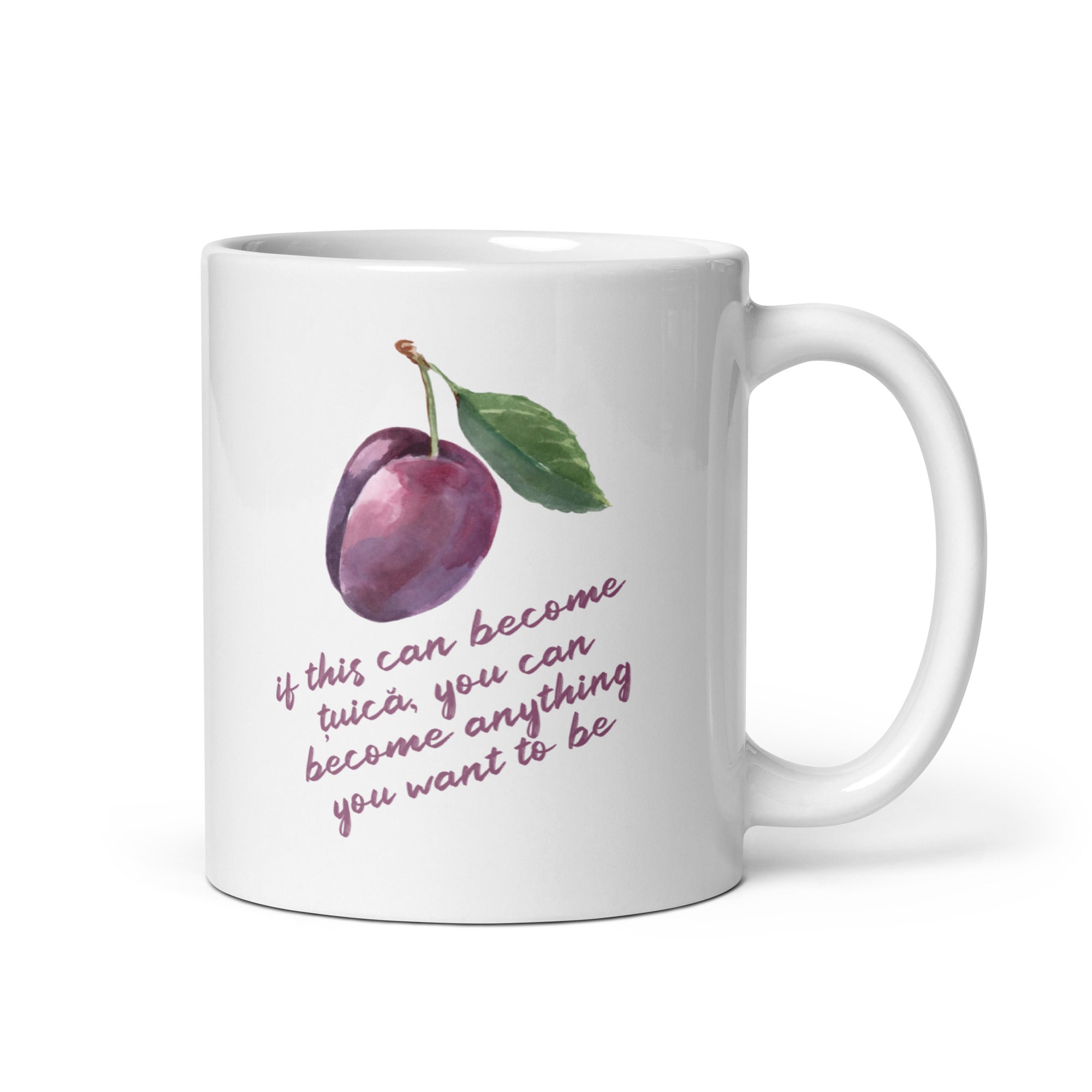 White mug with watercolor plum illustration and quote reading “If this can become țuică, you can become anything you want to be.”