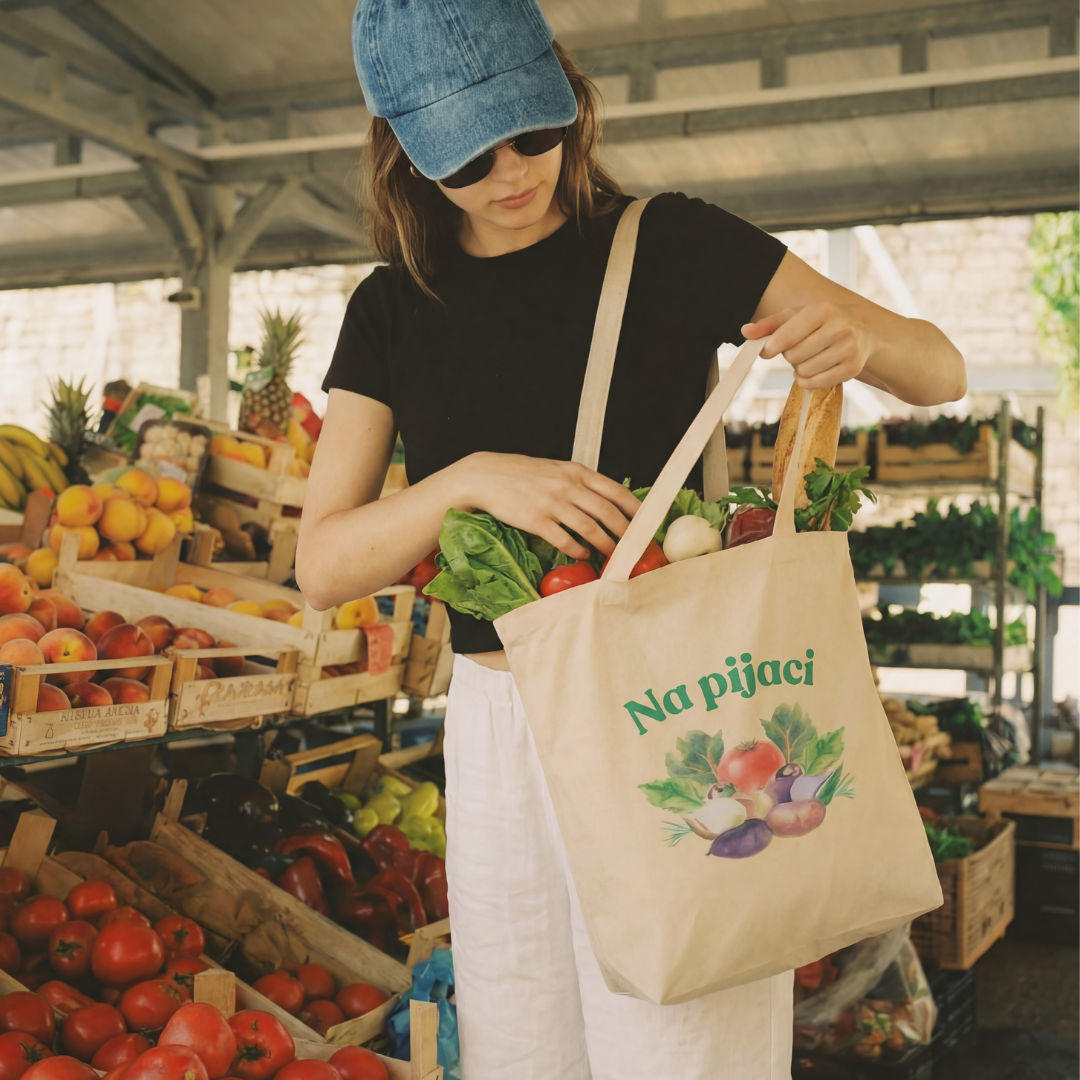 Person at a farmers market with a tote bag full of groceries
