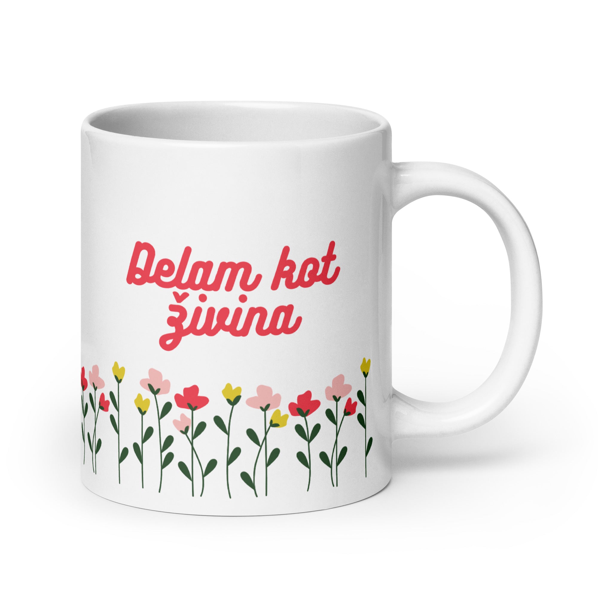 White mug with red text reading “Delam kot živina” above colorful flowers.