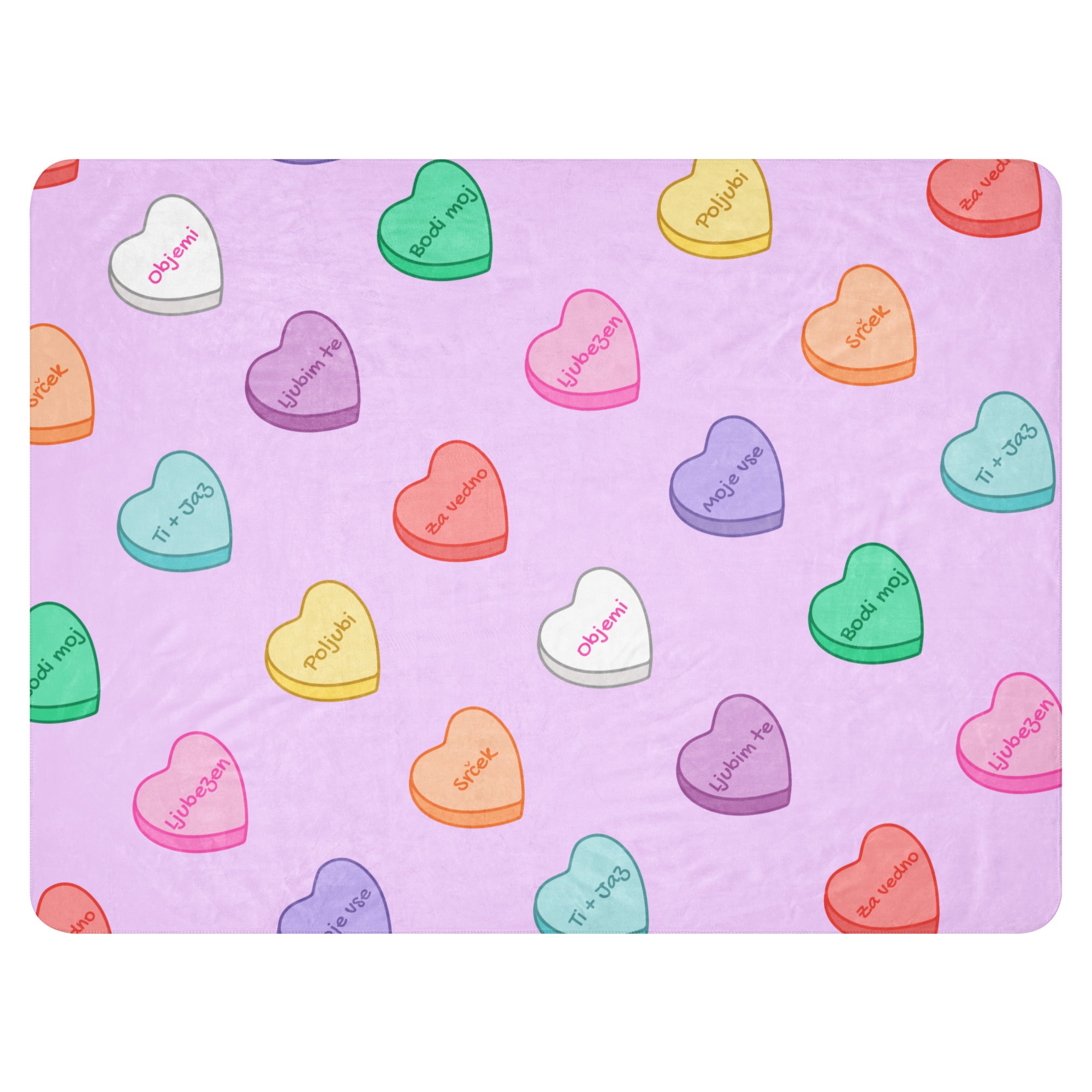 Lavender blanket with colorful sweetheart candy hearts and Slovenian love phrases.