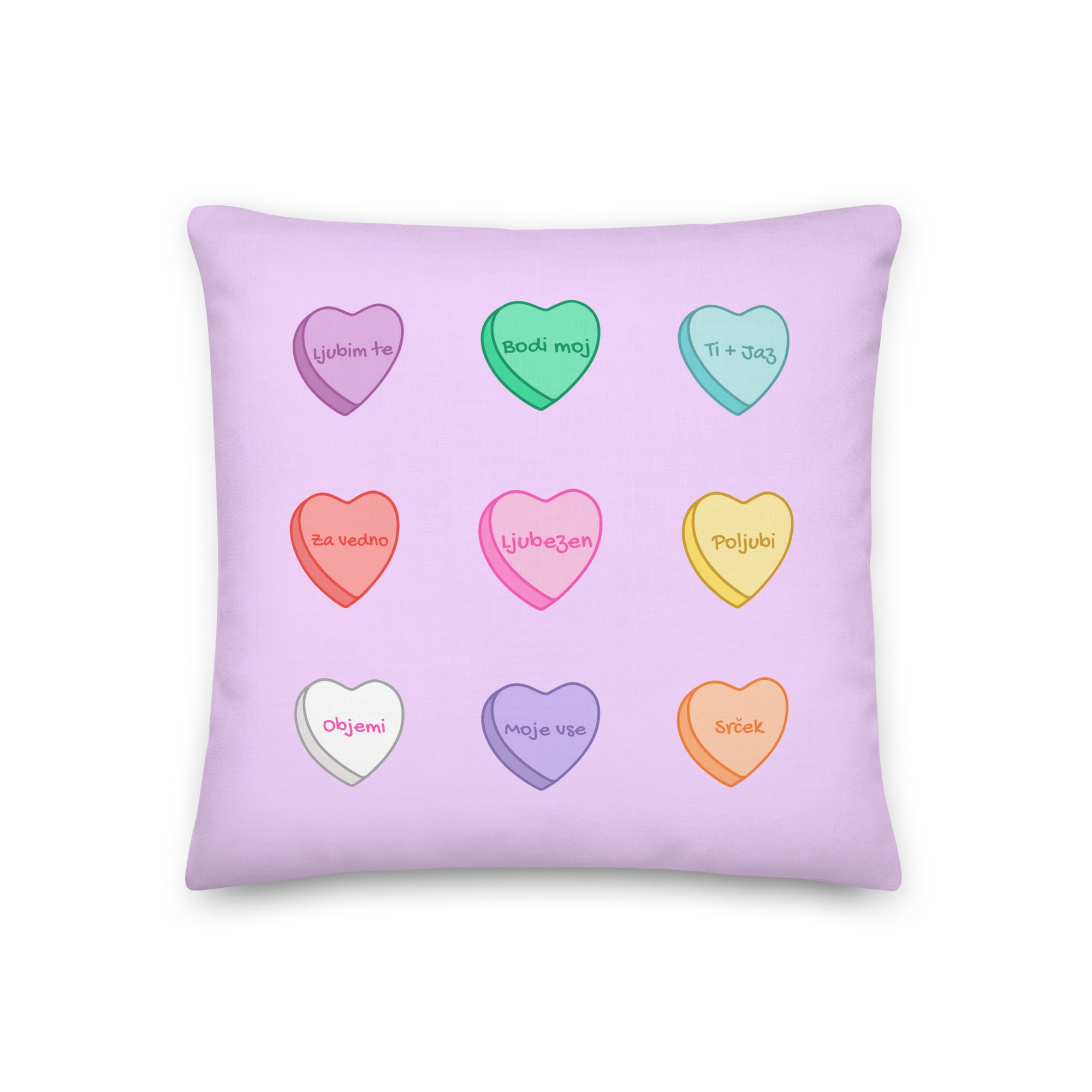 Pastel decorative pillow with candy heart designs featuring cute Slovenian love phrases