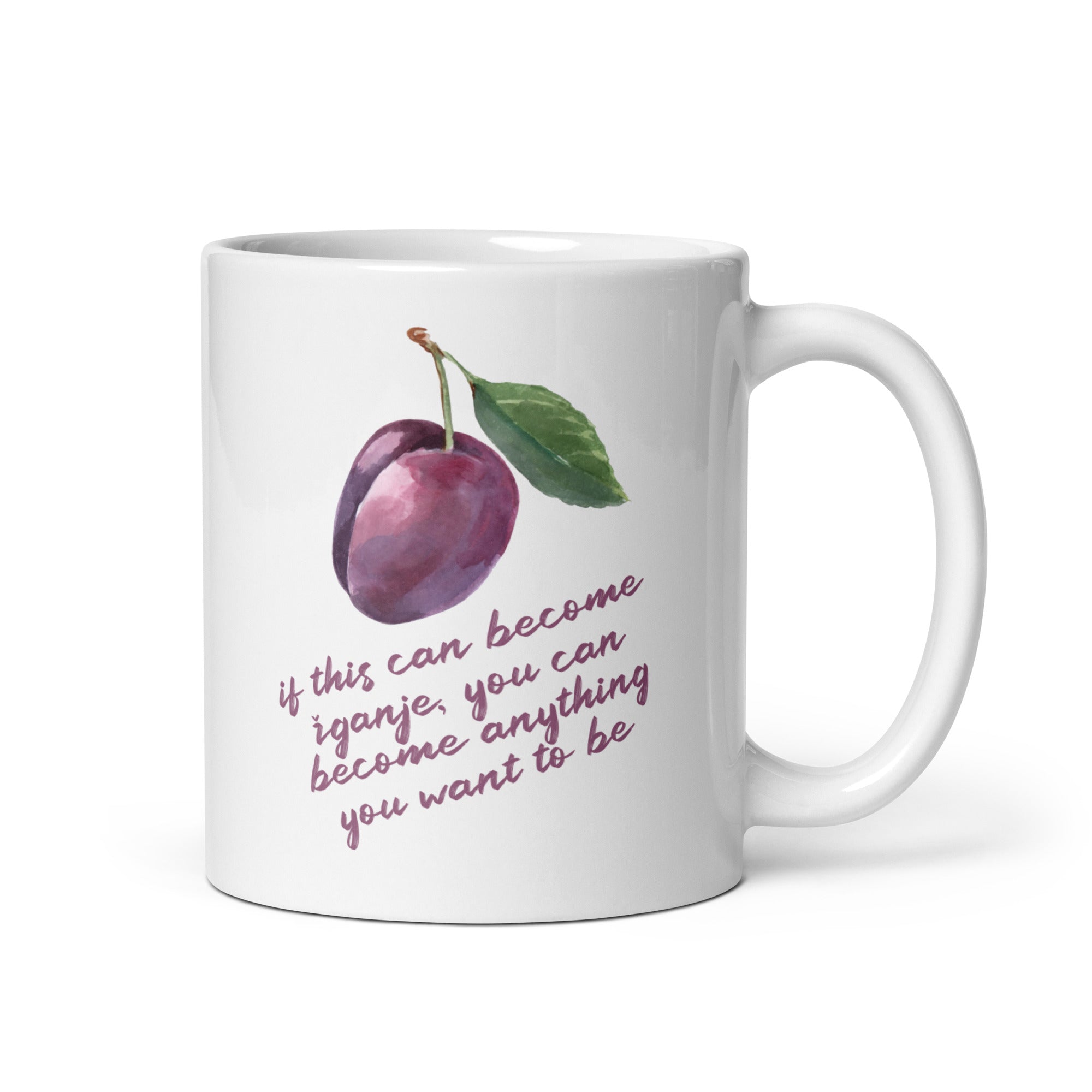 White mug with watercolor plum illustration and quote reading “If this can become žganje, you can become anything you want to be.”