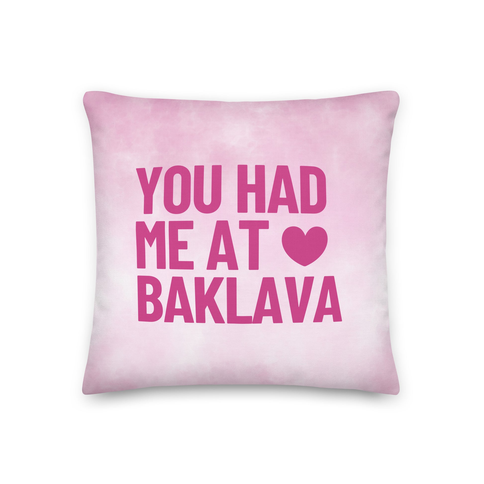 Pink pillow with the phrase “You Had Me at Baklava” featuring a heart detail, playful Balkan food love home decor cushion