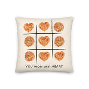 Decorative pillow featuring a tic-tac-toe design made of heart-shaped burek with the text “You won my heart”