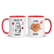 White ceramic mug with red handle showing “You’re the Yogurt” on one side and “to My Burek” on the other.
